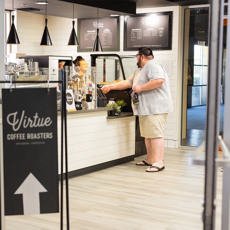 Customer ordering coffee at Virtue Coffee Roasters inside Desert Vineyard Church.