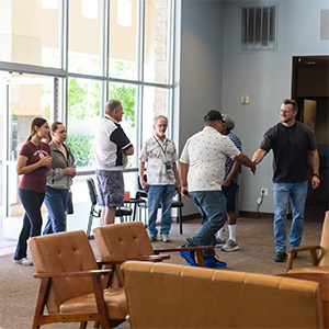 Volunteers greet and serve together at Desert Vineyard Church in Lancaster, CA, building community and welcoming guests.